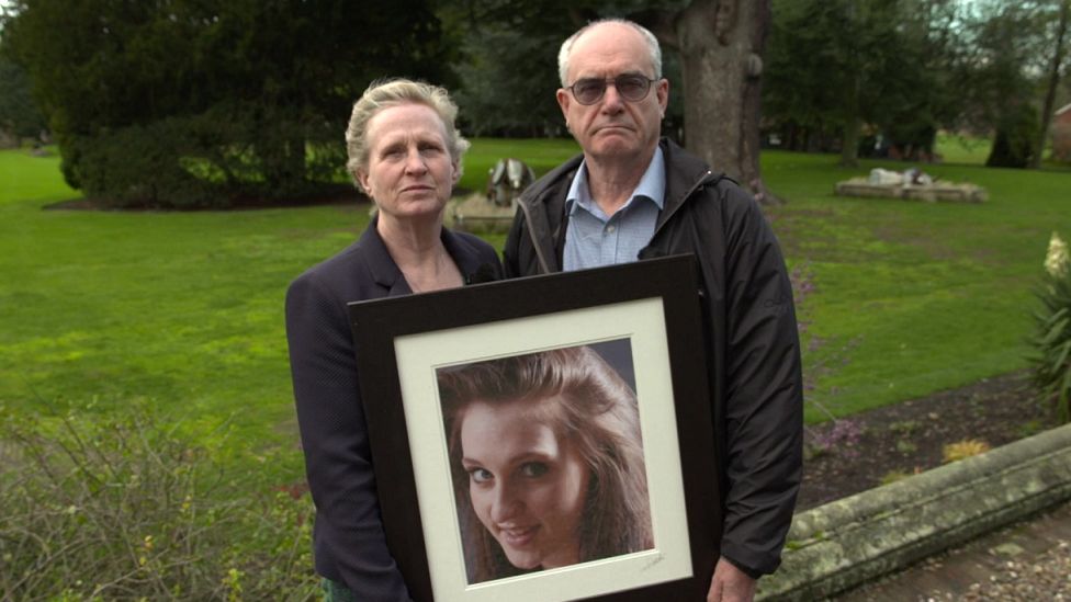 Sue Hills and Clive Ruggles holding up a photograph of their daughter