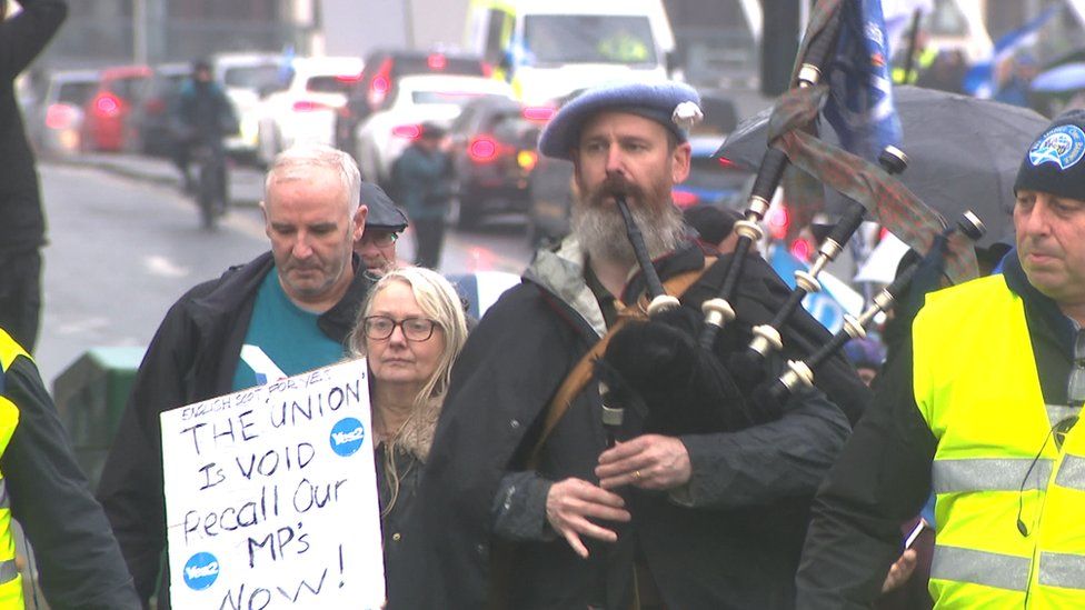A piper led the march through Glasgow