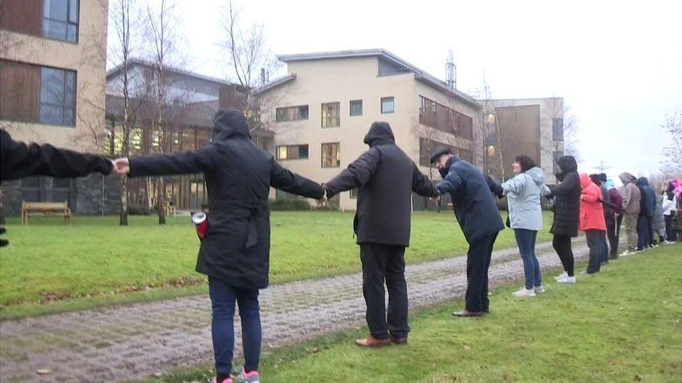 People linking arms in protest