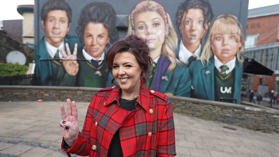 Writer Lisa McGee in front of a Derry Girls mural in Derry, ahead of the premiere for the third series of Channel 4"s Derry Girls at the Omniplex Cinema in Londonderry