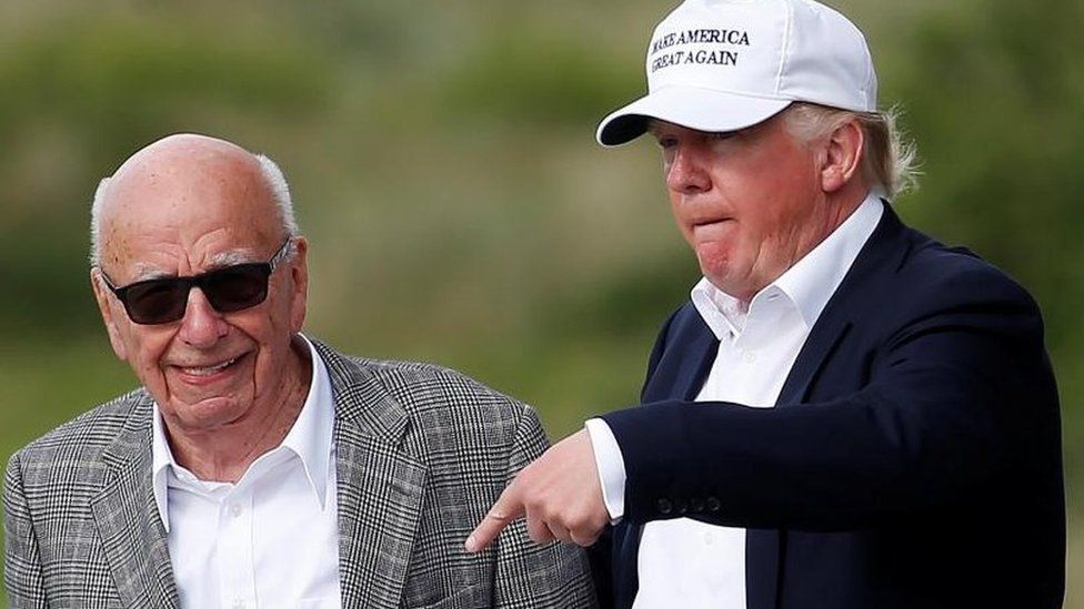 Donald Trump speaks to Rupert Murdoch (L) at Trump's golf course in Aberdeen, Scotland, in June 2016