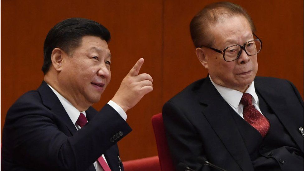 Chinese President Xi Jinping (L) talks to China's former president Jiang Zemin (R) during the closing of the 19th Communist Party Congress at the Great Hall of the People in Beijing on October 24, 2017.