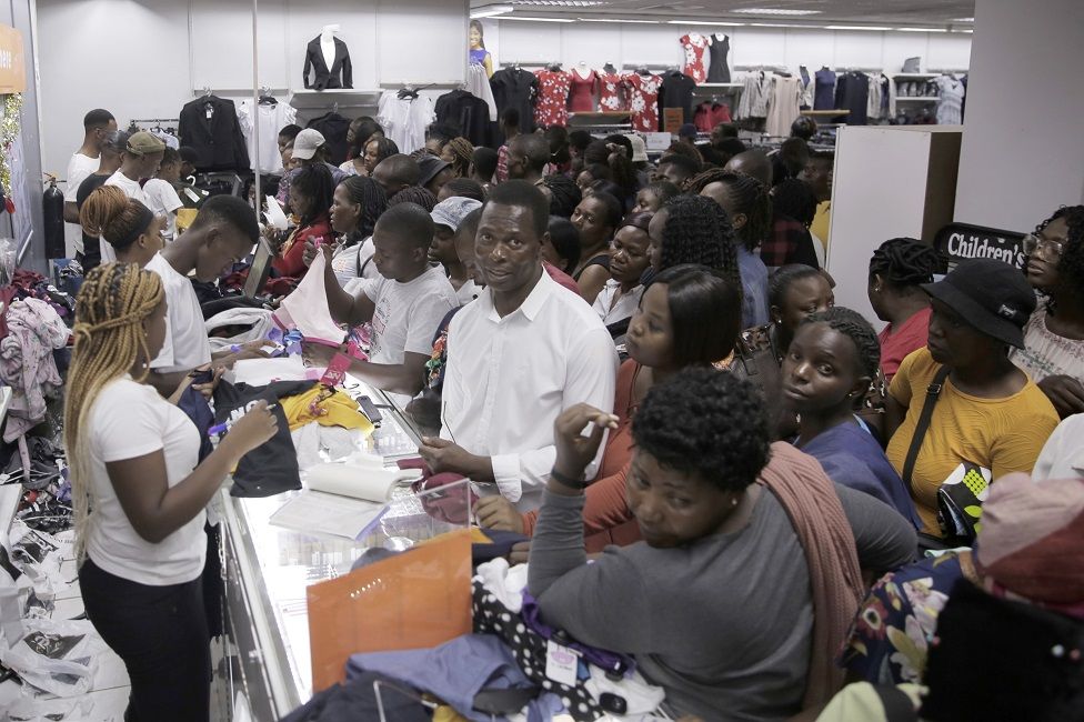 Customers shop at Jet Stores during Black Friday sales in Harare, Zimbabwe, 25 November 2022. With the country's hard-hit economy, Black Friday sales are seen as a welcoming relief, as many people tend to buy used clothing as a result of less disposable income.