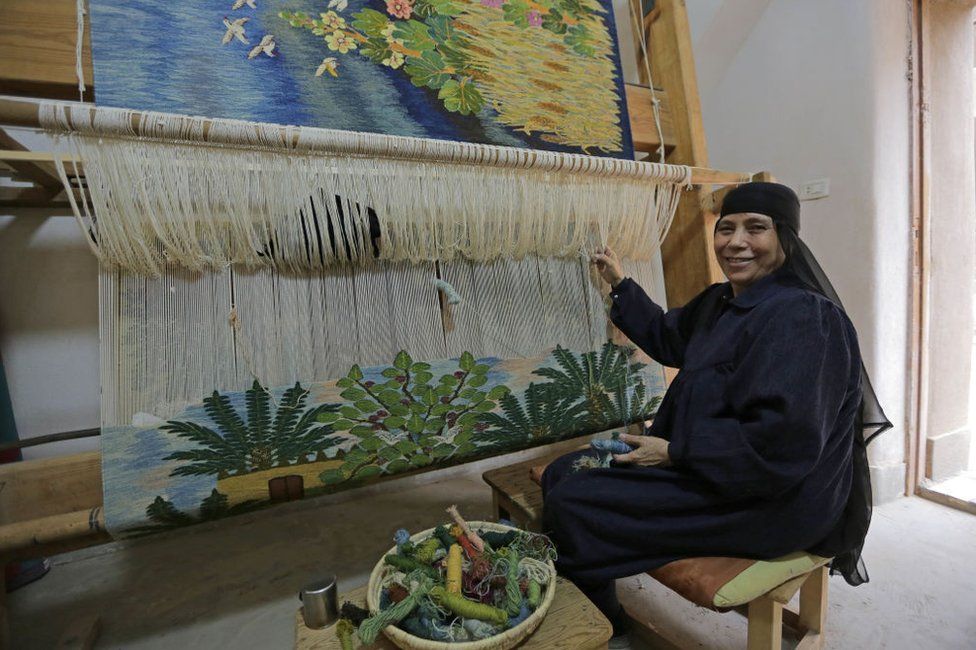 : A woman has been working at the loom for 45 years on November 28, 2022 in Giza, Egypt. The Ramses Wissa Wassef Art Centre is one of the most prominent weaving schools in Egypt. The workshop located in Harrania, near the pyramids of Giza, produces some of Egypt's finest carpets and rugs.