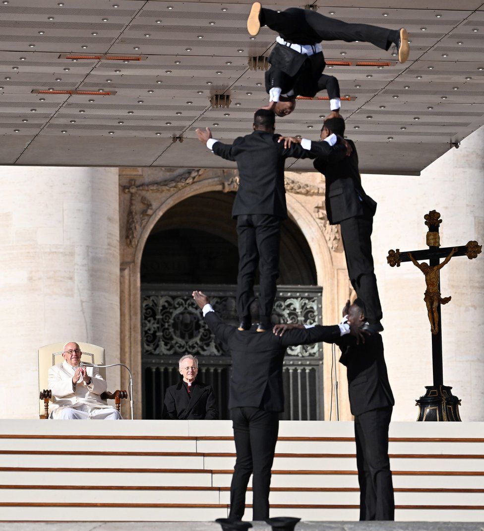 Pope Francis (L, back) watches circus artists from Kenya performing during his weekly general audience in Saint Peter"s Square, Vatican City, 30 November 2022.