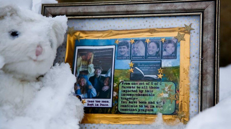 A small frame remembering Ethan Chapin, Madison Mogen, Xana Kernodle and Kaylee Goncalves sits in the snow