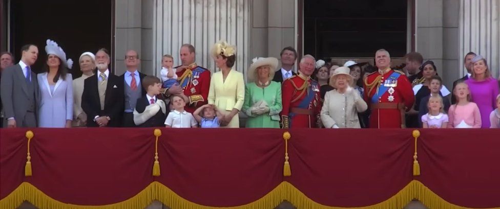 Footage taken from the new Harry & Meghan trailer of the royal family standing on the Buckingham Palace balcony