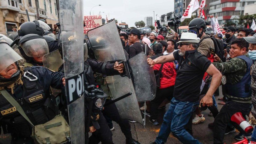 Protesters who support the ousted president Pedro Castillo confront the Police on the outskirts of the Prefecture of Lima,