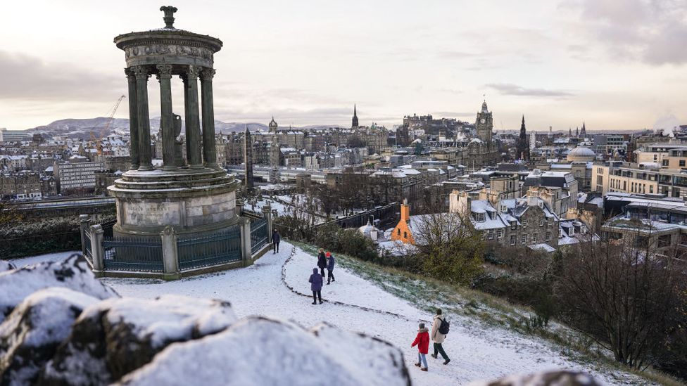 People are seen playing in the snow on Calton Hill on December 8, 2022 in Edinburgh, Scotland.