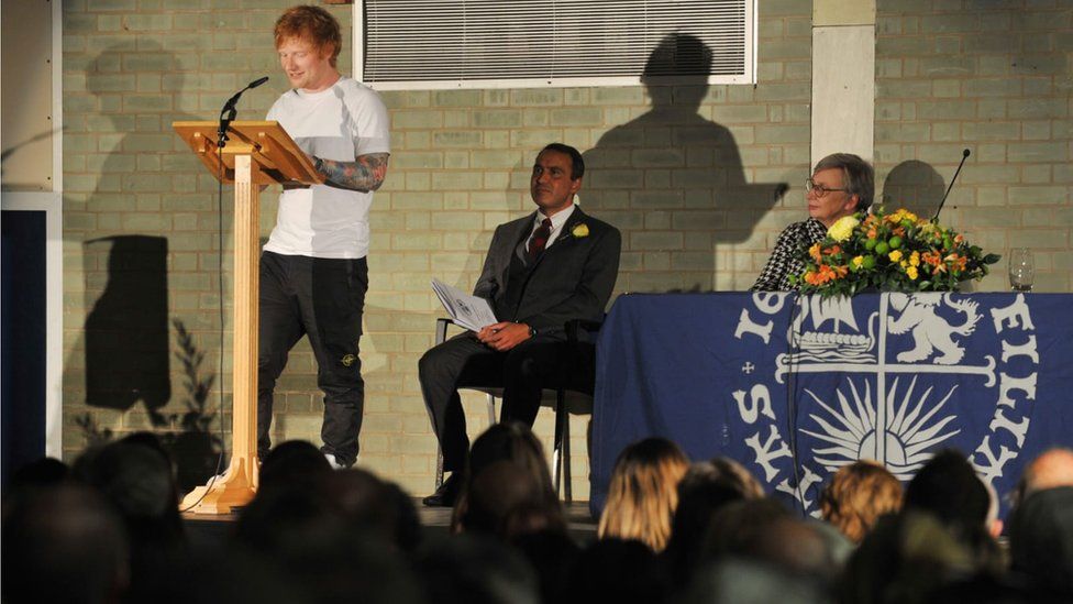 Ed Sheeran giving a speech at Thomas Mill High School's awards ceremony