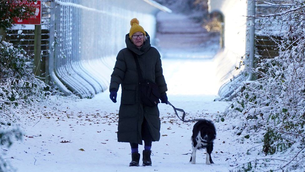 Woman and dog in snow in Durham
