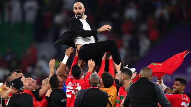 Morocco coach Walid Regragui is thrown into the air after the Atlas Lions beat Portugal at the World Cup in Qatar