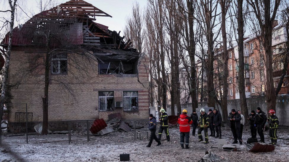Officials inspect a destroyed house after the Russian strikes on Kyiv