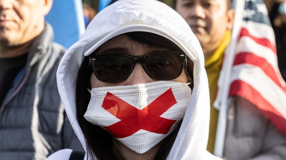 A masked protester at an anti-Chinese government protest in New York City on 5/12/2022