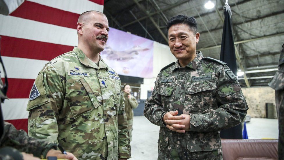 Lt Col Joshua McCullion (L), Commander of the US Space Forces Korea, talks with South Korean General Ahn Byung-seok, deputy commander of the South Korea-US Combined Forces Command, at Osan Air Base on Wednesday