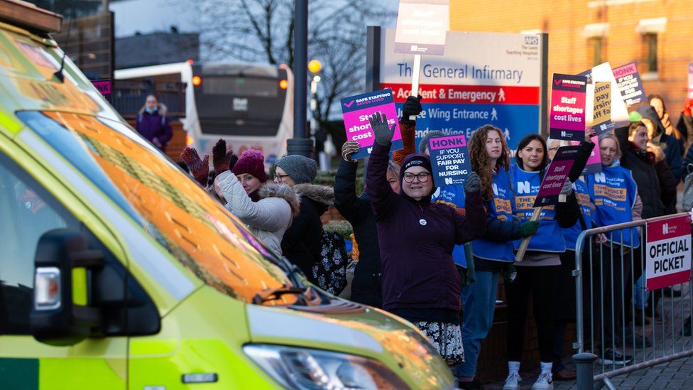 NHS nurses cheer as an ambulance passes the picket outside Leeds General Infirmary on 15 December 2022