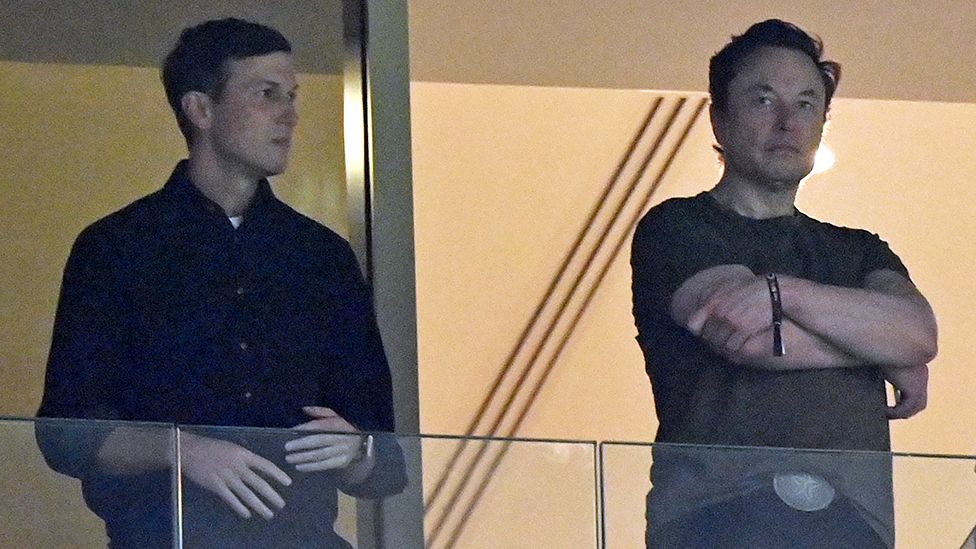 Elon Musk standing next to Jared Kushner