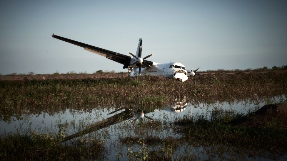 A crashed plane seen amid a flooded landscape in Bentiu, South Sudan