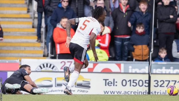 St Mirren's Jonah Ayunga is sent sprawling by Anthony Stewart