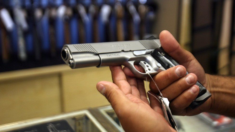 A man chooses a gun at the Gun Gallery in Glendale, California, 18 April 2007.
