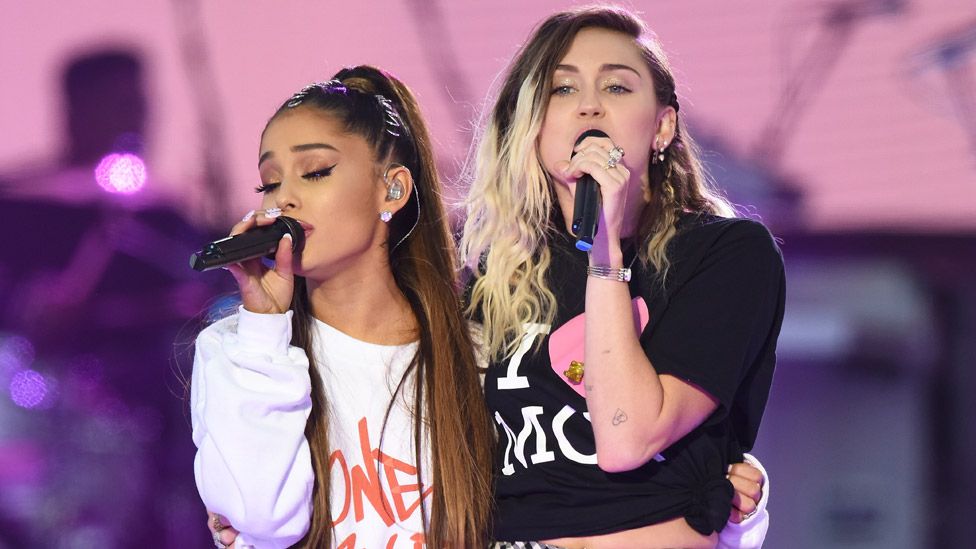 Ariana Grande (left) performed with Miley Cyrus