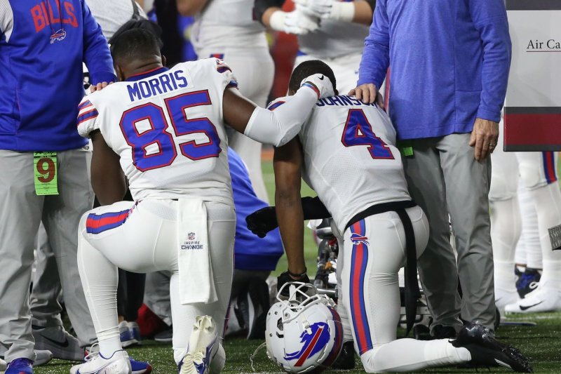 The Buffalo Bills players kneel on the sidelines after Damar Hamlin (3) was injured making a tackle against the Cincinnati Bengals during the first half of play at Paycor Stadium on Monday in Cincinnati. Photo by John Sommers II/UPI | <a href="/News_Photos/lp/97f5df22f3765febb14e0f18a369b86c/" target="_blank">License Photo</a>