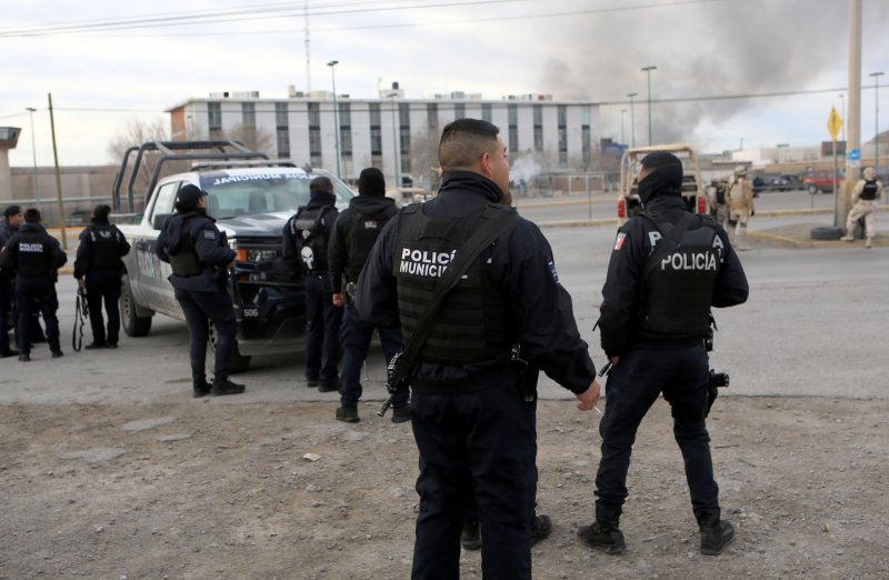Members of the Mexican Army and municipal police guard the area outside a prison, in Juarez, Mexico, where an attack took place on Monday. Photo by Luis Torres/EPA-EFE