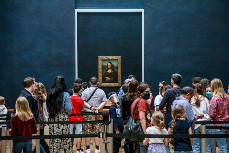 Visitors wearing protective face masks line up to see Leonardo da Vinci's painting La Gioconda (Mona Lisa), at the Louvre Museum in Paris, France, in July 2020. The museum reopened to the public after a nearly four-month closure due to the coronavirus pandemic. File Photo by Christophe Petit Tesson/EPA-EFE