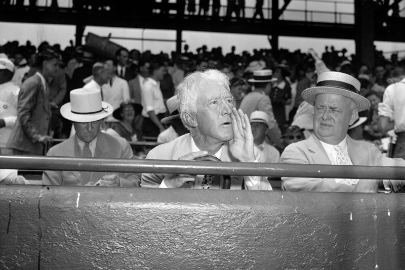 Judge Kenesaw Mountain Landis, commissioner of baseball, assumes his characteristic pose for the cameramen as he takes in the 1937 All-Star game in Washington, D.C., on July 7, 1937. On January 12, 1921, Landis was elected the first commissioner of Major League Baseball. File Photo by Library of Congress/UPI