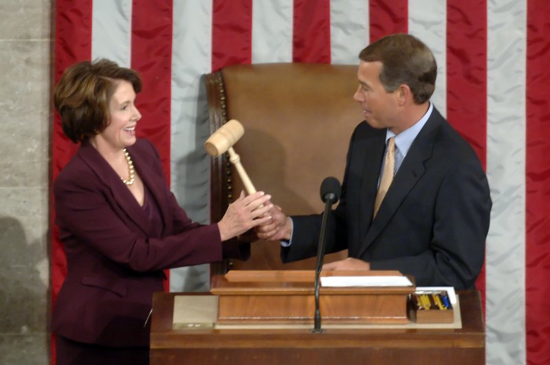 Incoming Speaking of the House Nancy Pelosi, D-Calif., receives the speaker's gavel from outgoing House Republican leader John Boehner, R-Ohio, as she becomes the first woman speaker of the House, in Washington on January 4, 2007. File Photo by Kevin Dietsch/UPI | <a href="/News_Photos/lp/9fa972c56b57321f6baa49067d9afe88/" target="_blank">License Photo</a>