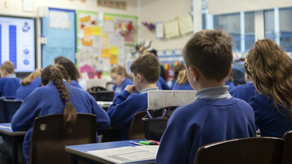 Stock photo of school pupils pictured from behind