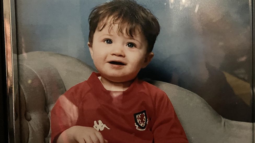 Neco Williams as a baby, wearing a Wales kit
