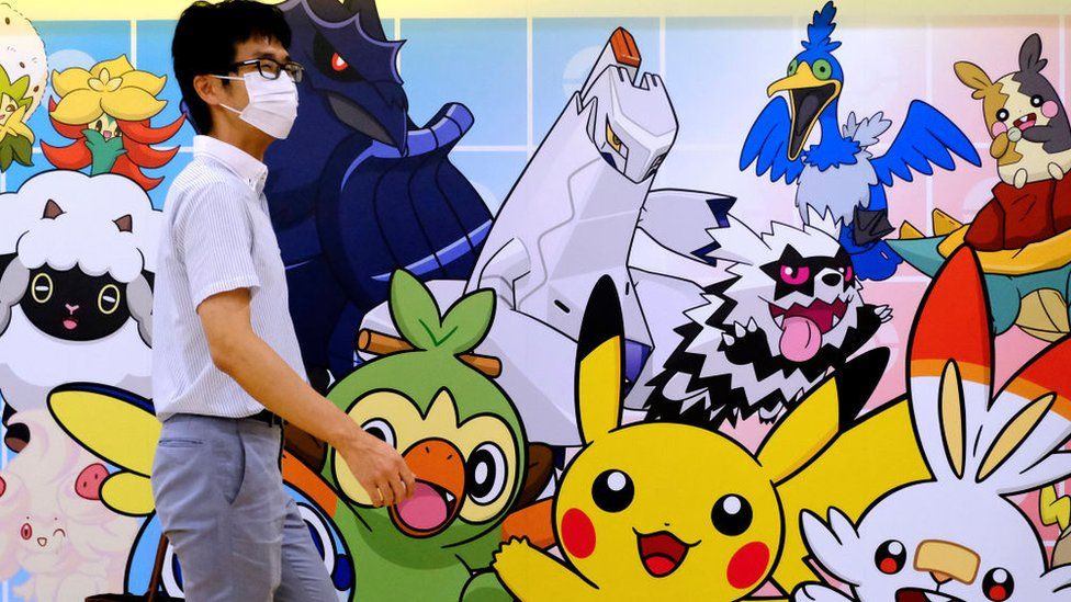 Man walks past at Pokemon Store graffiti at Tokyo