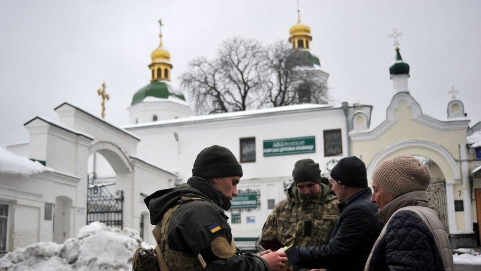 Ukraine's Security Service (SBU) servicemen check documents of visitors to Kyiv Pechersk Lavra monastery in Kyiv on November 22, 2022,