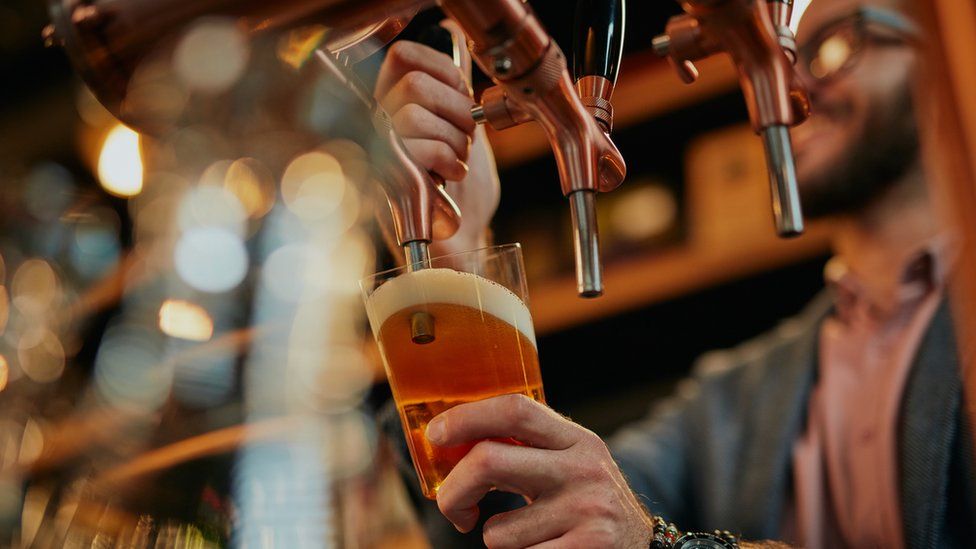 A man pouring a pint of beer