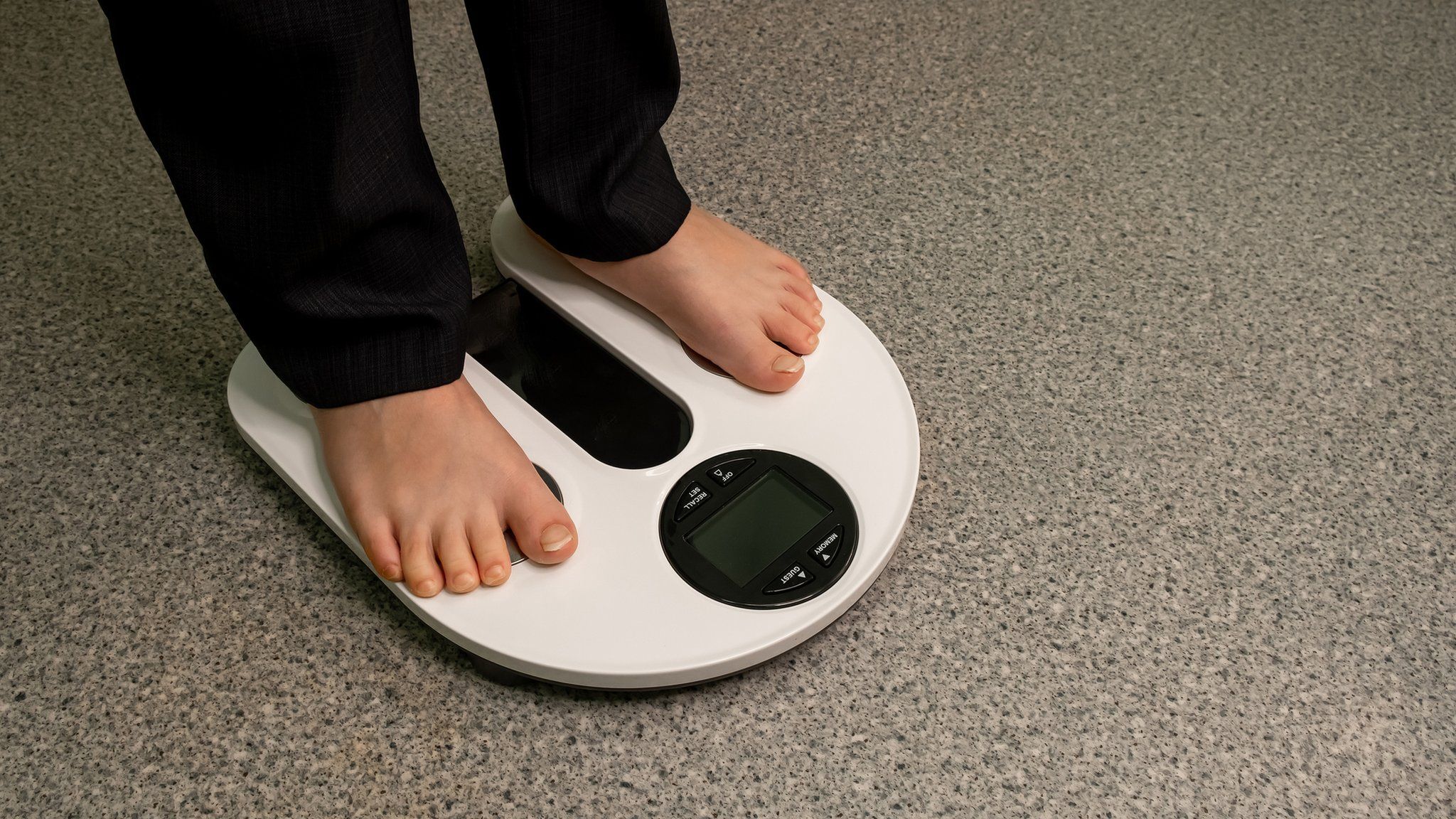 Photo of a child standing on a blank electronic scale