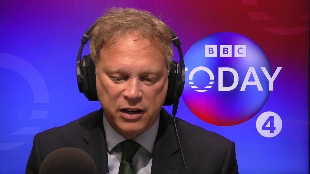 Business Secretary Grant Shapps wearing headphones in front of a microphoned during the Today programme interview