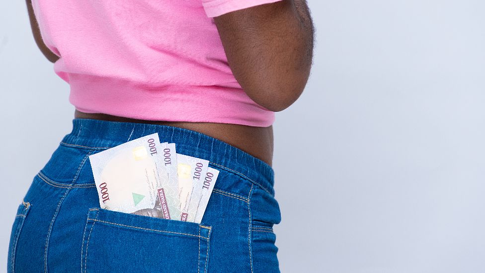 A woman with old 1,000 naira notes in her back pocket