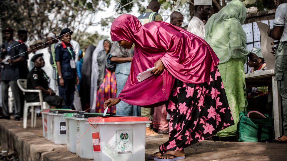 Nigerian woman casts her vote for a candidate in the presidential election at Agiya polling station a few hours before polls opened in Yola, Adamawa State, Nigeria on 23 February 2019
