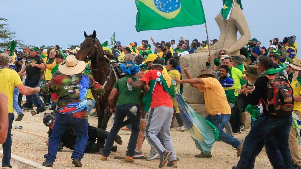 A military police officer fall from his horse during clashes with rioters in Brasília on 8 January