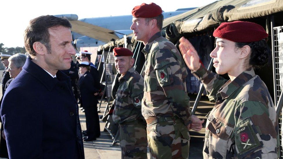 French President Emmanuel Macron greets soldiers as he visits the Mont-de-Marsan air base, southwestern France, to deliver his New Year address to the French Army on January 20, 2023