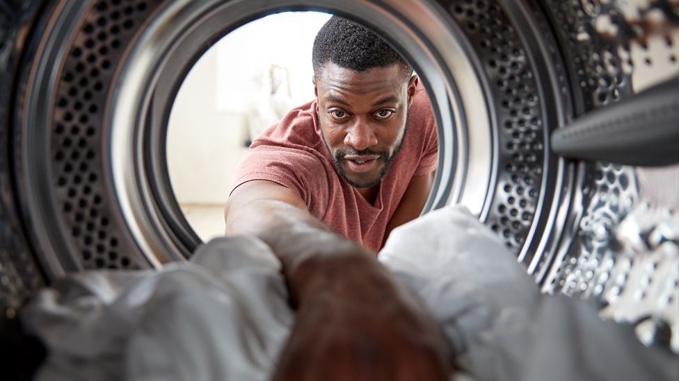 Man using a washing machine