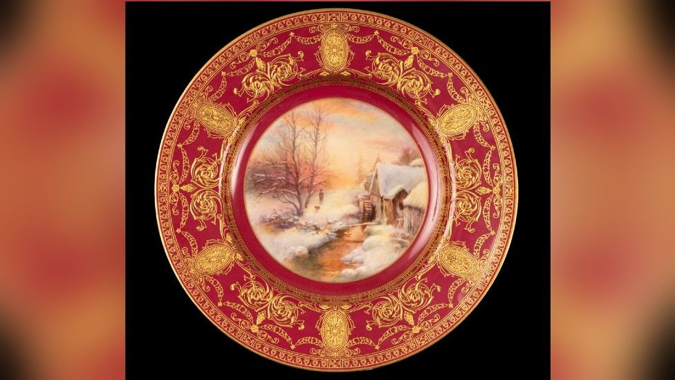 A red plate with gold decoration