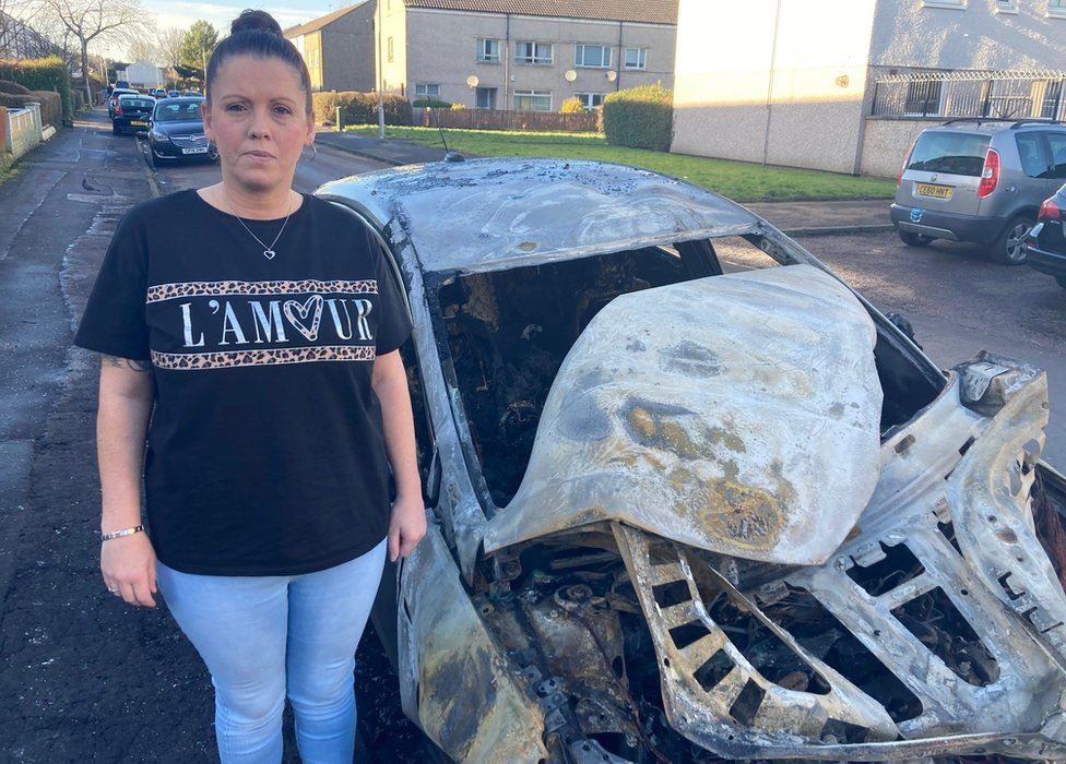 Nicola Elliott with burnt-out car