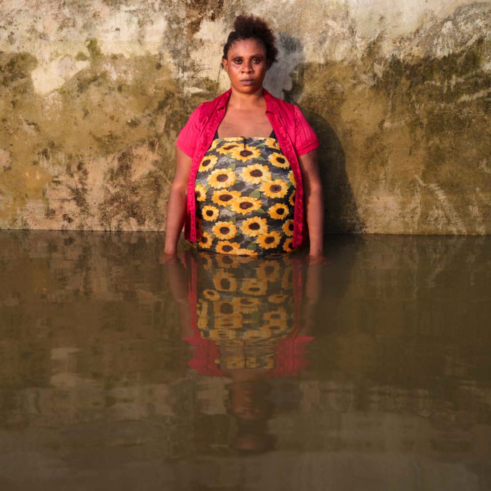 Fidelia Shedrack standing in flood water in her home in Yenagoa Municipality, Bayelsa State, Nigeria - November 2022
