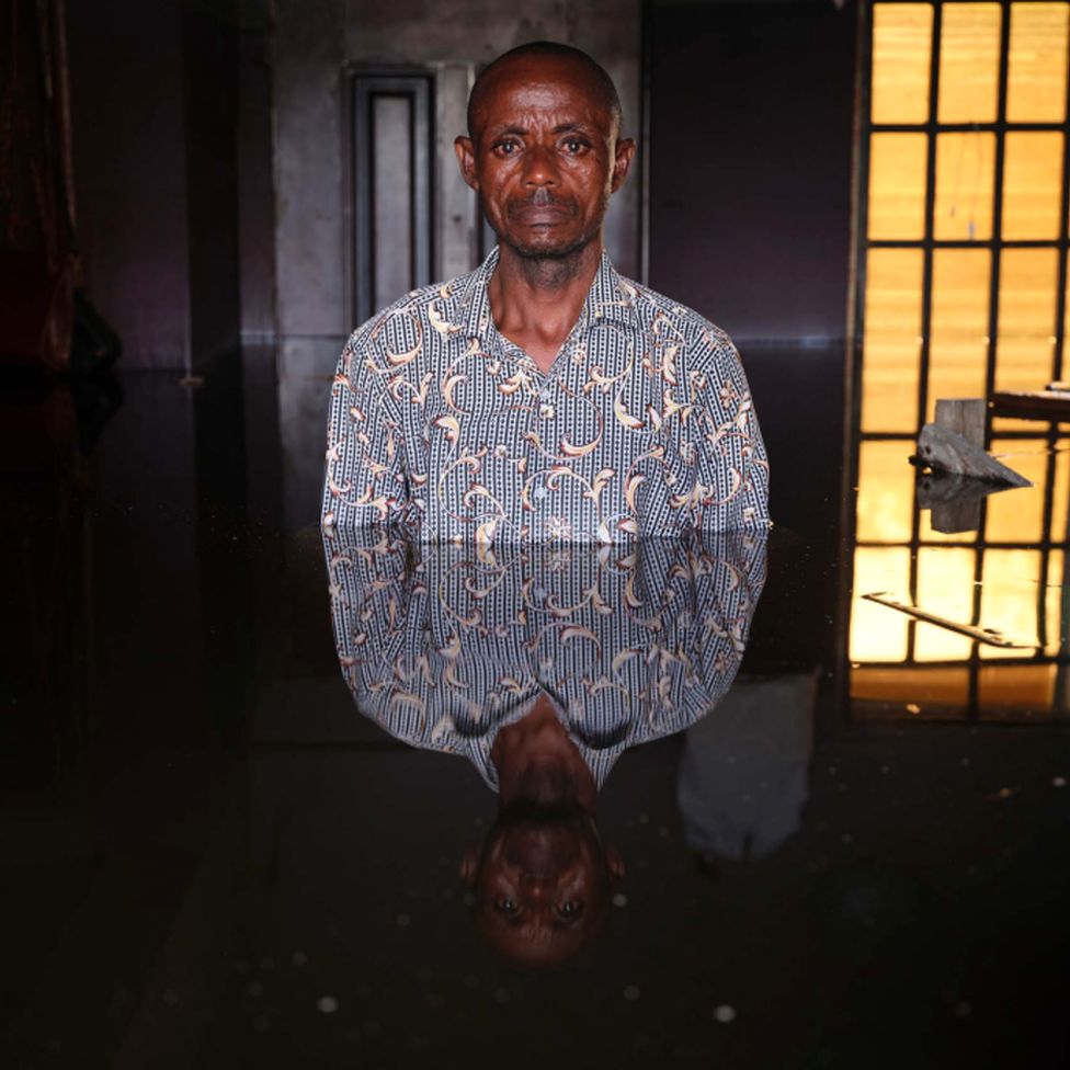Alawei Christian standing in flood water in his home in Ogbia Municipality, Bayelsa State, Nigeria - November 2022