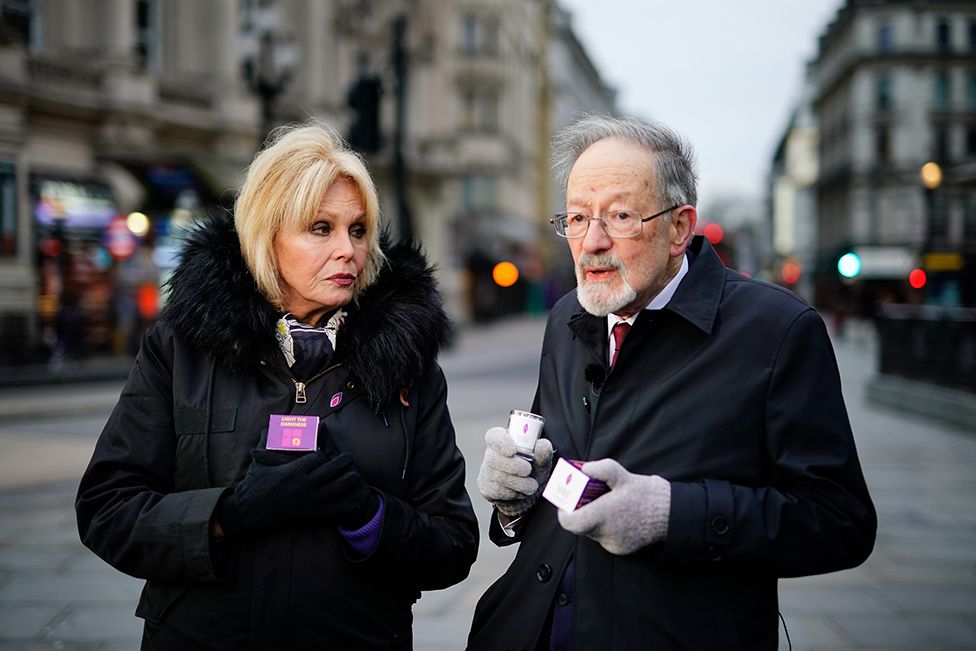 Dame Joanna Lumley handing out memorial candles at Piccadilly Circus, central London, alongside Martin Stern, a survivor of the Holocaust