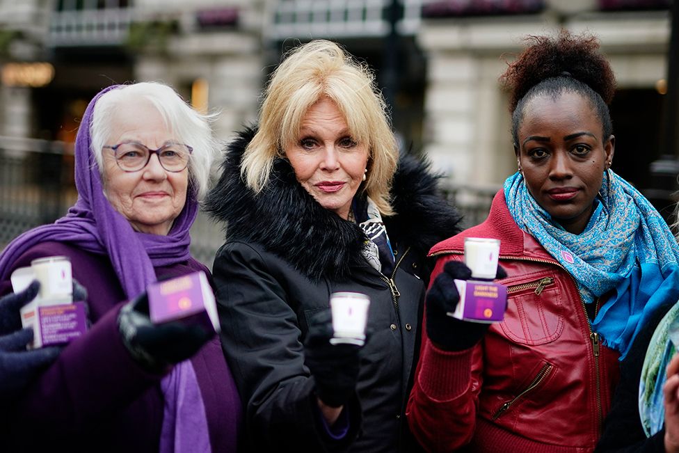 Dame Joanna Lumley hands out memorial candles at Piccadilly Circus, central London, alongside Holocaust survivor Joan Salter and Rwandan genocide survivor Antoinette Mutabazi