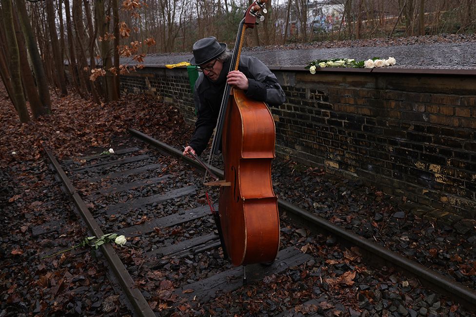 Musician Carmelo Leotta plays an improvisational piece on a contrabass at the Gleis 17 memorial in Berlin to mark Holocaust Memorial Day on 27 January 2023