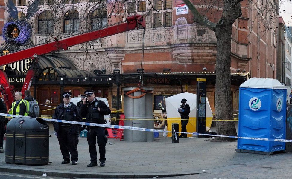 A police tent is erected at Cambridge Circus on the junction between Shaftesbury Avenue and Charing Cross Road in London, after a man died after being crushed by a telescopic urinal